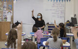 Illustrative: Children wearing face masks study in a classroom of the Kramim school in Jerusalem on their first day back to classes on November 1, 2020 (Olivier Fitoussi/Flash90)