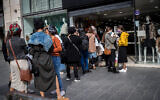 People shop on the first day of the reopening of street shops on Jaffa Street in downtown Jerusalem on November 8, 2020. (Yonatan Sindel/Flash90)