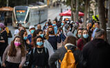 Israelis wearing face masks walk on Jaffa Street in downtown Jerusalem, on November 19, 2020. (Olivier Fitoussi/Flash90)