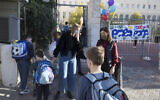 Illustrative: Children enter the Beit Hakerem school in Jerusalem on November 24, 2020 (Olivier Fitoussi/Flash90)