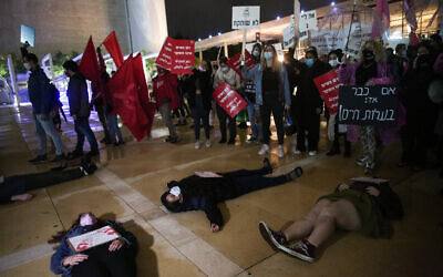 Activists protest against recent cases of violence against women at Habima square in Tel Aviv on November 25, 2020. (Miriam Alster/Flash90)