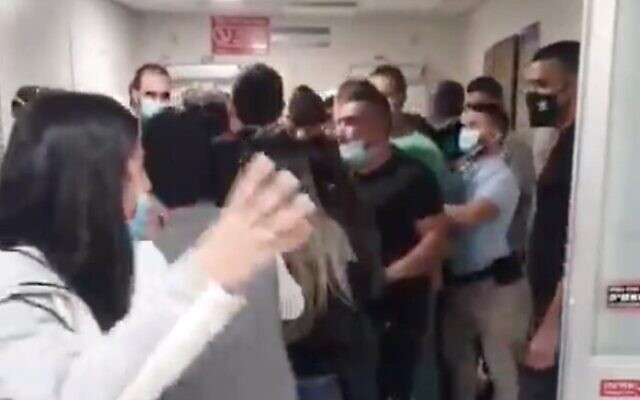 Screen capture from video of a scuffle at the Assaf Harofeh Medical Center as family members try to reach a woman who died of the coronavirus. (Twitter) Screen capture from video of a scuffle at the Assaf Harofeh Medical Center as family members try to reach a woman who died of the coronavirus. (Twitter)