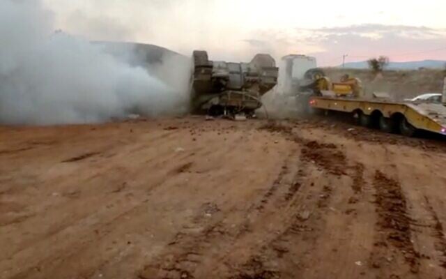 An IDF tank flips over while driving onto a transport truck in the Jordan Valley on Novermber 22, 2020. (Screen capture) An IDF tank flips over while driving onto a transport truck in the Jordan Valley on Novermber 22, 2020. (Screen capture)