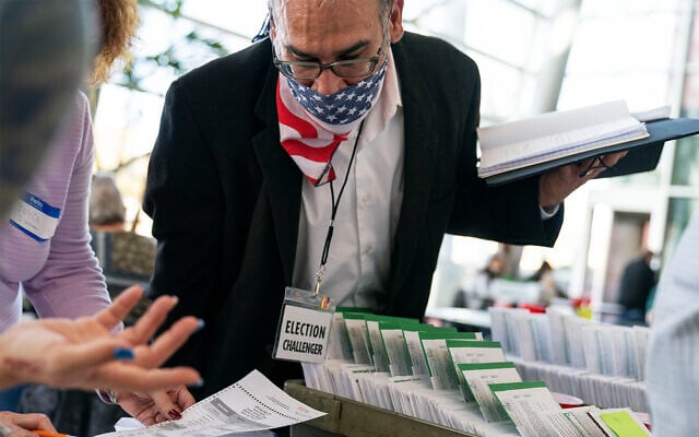 A non-partisan poll election challenger observes election inspectors as they begin to count ballots on Election Day at City Hall in Warren, Michigan, Nov. 3, 2020. (AP Photo/David Goldman) A non-partisan poll election challenger observes election inspectors as they begin to count ballots on Election Day at City Hall in Warren, Michigan, Nov. 3, 2020. (AP Photo/David Goldman)