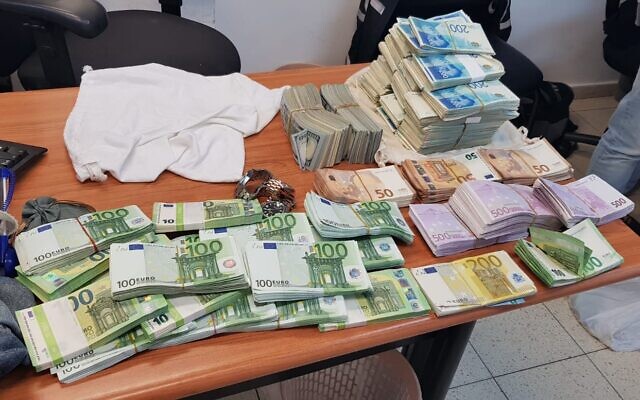 Illustrative: Cash seized at the Tel Aviv apartment of fraud suspect Ilan Marco, on November 11, 2020 (Israel Police) Illustrative: Cash seized at the Tel Aviv apartment of fraud suspect Ilan Marco, on November 11, 2020 (Israel Police)