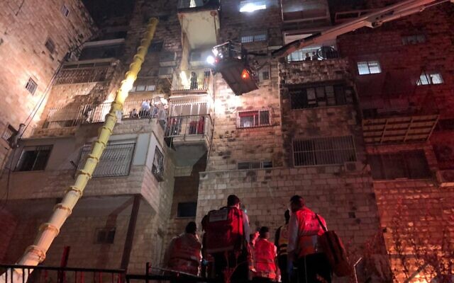 Rescue workers on the scene of a fire at a residential complex in the Jerusalem neighborhood of Romema, November 24, 2020 (United Hatzalah)