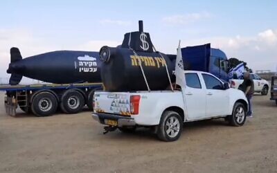 A convoy of vehicles carrying mock submarines are headed to Jerusalem on Saturday, November 28, 2020, to demand an official investigation into the so-called submarine affair that has ensnared associates of PM Netanyahu but not the premier himself. (Screen capture / Investigation Now FB page)