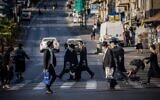 Ultra-Orthodox Jews cross the road at the Bar-Ilan junction in Jerusalem, on October 19, 2020. (Yonatan Sindel/Flash90)