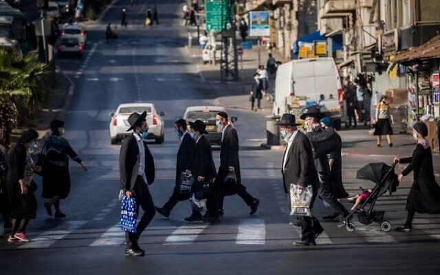 Ultra-Orthodox Jews cross the road at the Bar-Ilan junction in Jerusalem, on October 19, 2020. (Yonatan Sindel/Flash90) Ultra-Orthodox Jews cross the road at the Bar-Ilan junction in Jerusalem, on October 19, 2020. (Yonatan Sindel/Flash90)