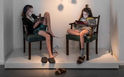 Artist Inbal Hoffman's children pose in Ticho House chairs as part of her new exhibit, 'Mundane Heights,' which opened virtually on October 29, 2020. (courtesy, Israel Museum)