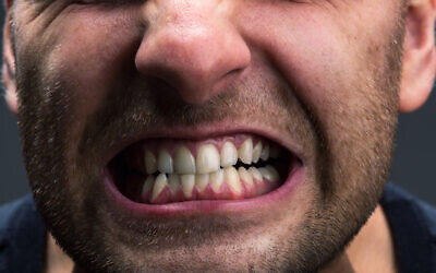 A man clenching his jaw (Nomadsoul1 via iStock by Getty Images)