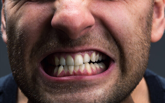 A man clenching his jaw (Nomadsoul1 via iStock by Getty Images)
