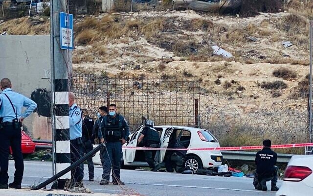 Police inspect a car used in a suspected attempted car-ramming at the a-Zaim crossing outside Jerusalem on November 25, 2020. (Shlomo Mor) Police inspect a car used in a suspected attempted car-ramming at the a-Zaim crossing outside Jerusalem on November 25, 2020. (Shlomo Mor)