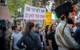 Israeli secular protesters shout slogans in Jerusalem on August 12, 2017, during a demonstration of ultra-Orthodox Jews against businesses that operate on Saturdays in the city.  The slogan, which rhymes in Hebrew, says, 'We're not against the Sabbath, we're against religious pressure.' (Yonatan Sindel/Flash90 )