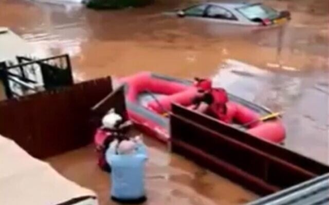 Resident is rescued after their home floods in Ness Ziona, November 21, 2020 (Screen grab/Channel 12) Resident is rescued after their home floods in Ness Ziona, November 21, 2020 (Screen grab/Channel 12)