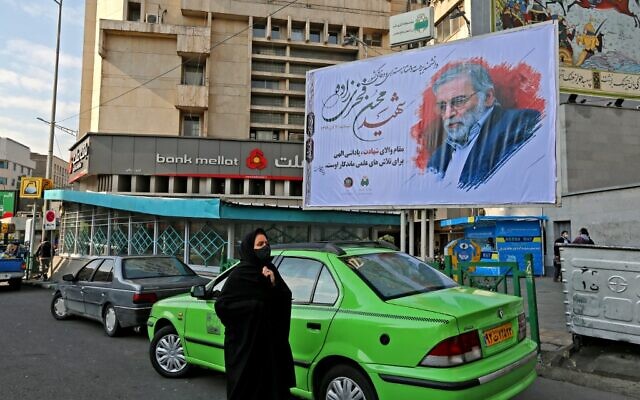 A woman walk by a billboard in honour of slain nuclear scientist Mohsen Fakhrizadeh in the Iranian capital Tehran, on November 30, 2020. (ATTA KENARE/AFP) A woman walk by a billboard in honour of slain nuclear scientist Mohsen Fakhrizadeh in the Iranian capital Tehran, on November 30, 2020. (ATTA KENARE/AFP)