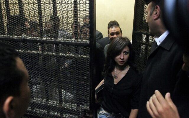 One of fourteen Egyptians, who refused to be identified, on trial on charges of receiving illicit foreign funds to operate unlicensed NGOs, leaves a cage in a court room in the capital Cairo, March 8, 2012. (Photo by Khaled DESOUKI / AFP) One of fourteen Egyptians, who refused to be identified, on trial on charges of receiving illicit foreign funds to operate unlicensed NGOs, leaves a cage in a court room in the capital Cairo, March 8, 2012. (Photo by Khaled DESOUKI / AFP)