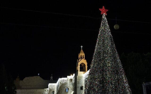 A picture taken on December 5, 2020, shows the Christmas tree after a lighting ceremony in the biblical city of Bethlehem in the West Bank, closed to the public due to the COVID-19 coronavirus pandemic (Emmanuel DUNAND / AFP)
