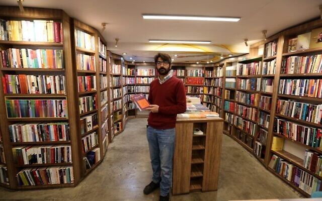 Manager Reza Bahrami poses for a picture at a bookstore of the Nashre-Cheshmeh Publishing House on Karim Khan street in the Iranian capital Tehran, on December 5, 2020. (ATTA KENARE / AFP) Manager Reza Bahrami poses for a picture at a bookstore of the Nashre-Cheshmeh Publishing House on Karim Khan street in the Iranian capital Tehran, on December 5, 2020. (ATTA KENARE / AFP)