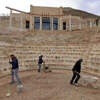 Workers keep flat the restored floor of the ancient theater built by Herod the Great between 23-15 BCE in the Judaean desert, southeast of Bethlehem in the West Bank, on December 7, 2020. (Menahem Kahana/AFP)