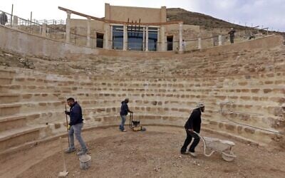 Workers keep flat the restored floor of the ancient theater built by Herod the Great between 23-15 BCE in the Judaean desert, southeast of Bethlehem in the West Bank, on December 7, 2020. (Menahem Kahana/AFP)