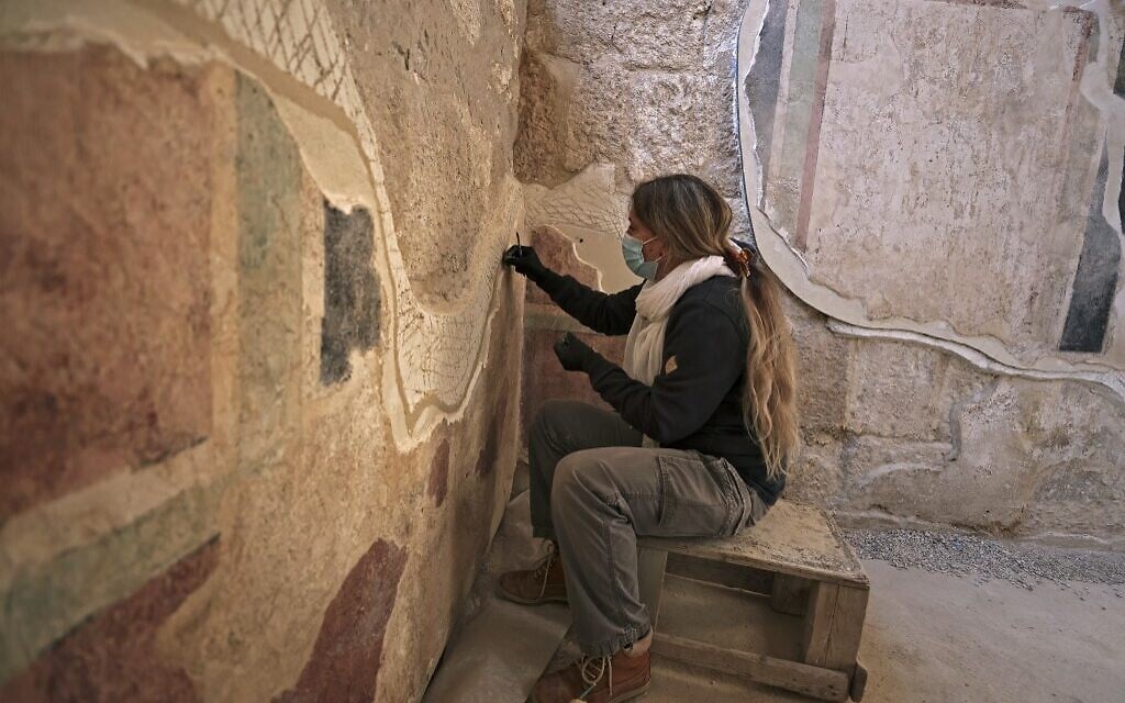 A conservator of the Israel Antiquities Authority restores ancient frescoes at the arches corridor leading to the Herodium palace built by Herod the Great between 23-15 BCE in the Judaean desert, southeast of Bethlehem (Menahem KAHANA / AFP)