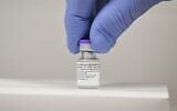 In this file photo taken on December 8, 2020 a member of staff poses with a vial of the Pfizer-BioNTech COVID-19 vaccine at a vaccination health center in Cardiff, South Wales. (Justine Tallis/AFP)