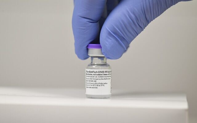 In this file photo taken on December 8, 2020 a member of staff poses with a vial of the Pfizer-BioNTech COVID-19 vaccine at a vaccination health center in Cardiff, South Wales. (Justine Tallis/AFP) In this file photo taken on December 8, 2020 a member of staff poses with a vial of the Pfizer-BioNTech COVID-19 vaccine at a vaccination health center in Cardiff, South Wales. (Justine Tallis/AFP)