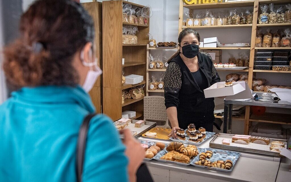 A Moroccan Jewish woman buys pastries at the kosher bakery *Madame Khal' in the western Moroccan port city of Casablanca, on December 11, 2020. (FADEL SENNA / AFP)