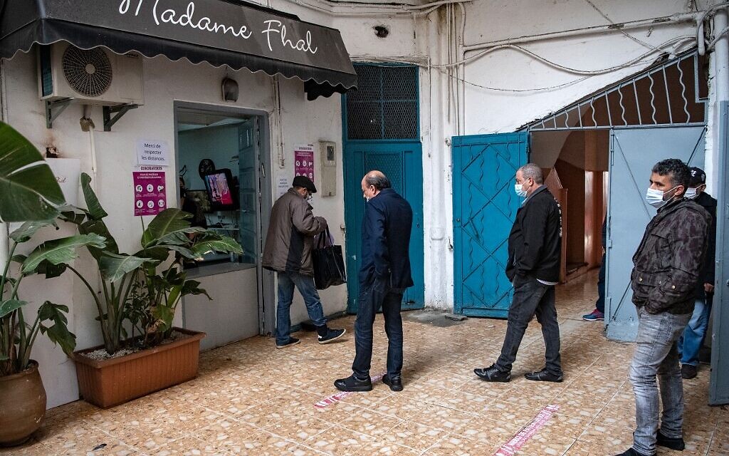 Moroccan Jewish and Muslim men queue in front of the kosher pbakery 'Madame Khal' in the western Moroccan port city of Casablanca, on December 11, 2020. (FADEL SENNA / AFP)