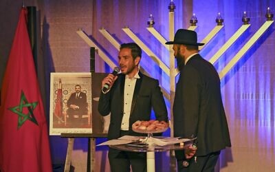 Rabbi Levi Banon and a member of Casablanca's Jewish community during a ceremony on the fifth night of the Jewish holiday of Hanukkah on December 14, 2020 in Casablanca. (FADEL SENNA/AFP)