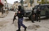 Illustrative: Palestinian Authority security forces in balaclavas stand by an armored vehicle at the entrance to Balata camp, near the West Bank city of Nablus, on December 15, 2020.  (Photo by JAAFAR ASHTIYEH / AFP)