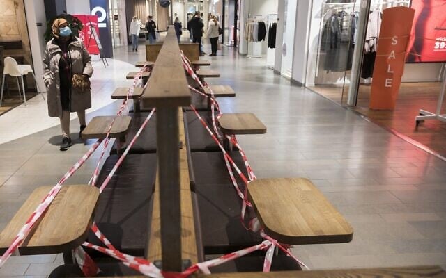 Benches are taped off as people stroll at the Granbystaden shopping center in Uppsala, Sweden, on December 18, 2020, during the ongoing coronavirus pandemic (Henrik MONTGOMERY/AFP) Benches are taped off as people stroll at the Granbystaden shopping center in Uppsala, Sweden, on December 18, 2020, during the ongoing coronavirus pandemic (Henrik MONTGOMERY/AFP)