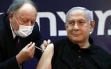 Prime Minister Benjamin Netanyahu receives a coronavirus vaccine, from his personal physician Dr. Tzvi Berkovitz, at Sheba Medical Center in Ramat Gan, on December 19, 2020, becoming the first Israeli to get the vaccine. (Amir Cohen/Pool/AFP)