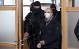 Stephan Balliet (C), who shot dead two people after an attempt to storm a synagogue in Halle an der Saale, eastern Germany, wears a face mask as he arrives for the start of the 26th day of the trial on December 21, 2020 at the district court in Magdeburg, eastern Germany (Ronny Hartmann / AFP)