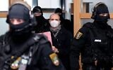Stephan Balliet (C), who shot dead two people after an attempt to storm a synagogue in Halle an der Saale, eastern Germany, wears a face mask as he arrives for the start of the 26th day of the trial on December 21, 2020, at the district court in Magdeburg, eastern Germany (Ronny Hartmann/ AFP)