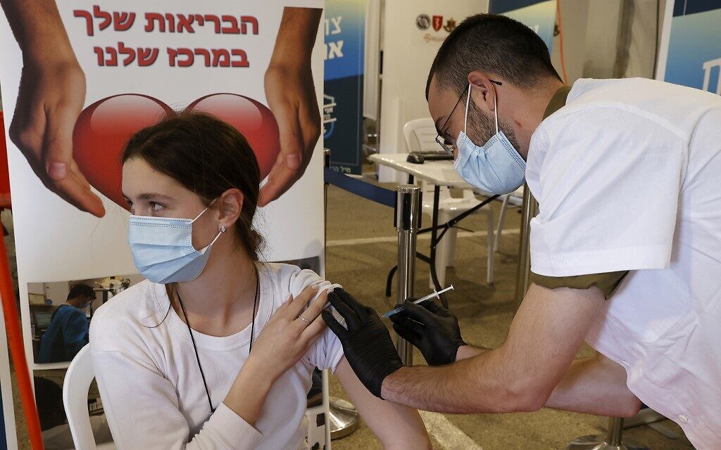 An IDF medic gets vaccinated against the COVID-19 coronavirus at the medical center of Tzrifin military base in Rishon Lezion on December 28, 2020. (JACK GUEZ / AFP)