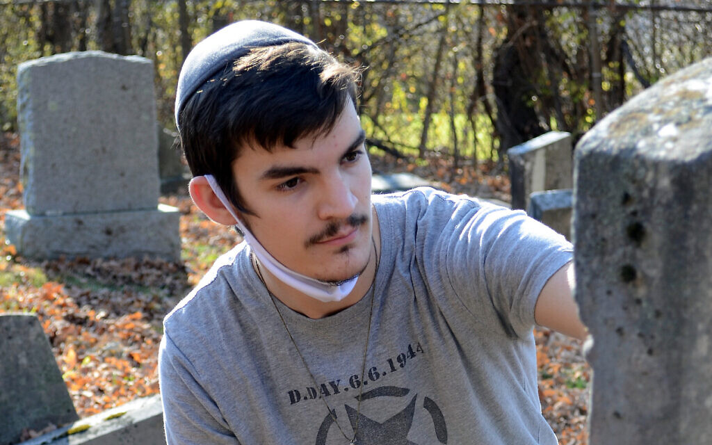Netanel Crispe works on a headstone at the oldest Jewish cemetery in Vermont. (David LaChance/Bennington Banner/ via JTA) Netanel Crispe works on a headstone at the oldest Jewish cemetery in Vermont. (David LaChance/Bennington Banner/ via JTA)