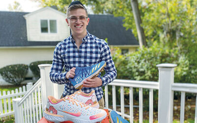 Ari Solomon displays some of the cleats he’s designed. (Courtesy)