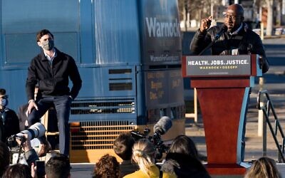 Rev. Raphael Warnock (R) speaks at a campaign event in Atlanta to promote voting in the Senate runoff election as Jon Ossoff, a fellow Democrat also running for Senate in Georgia, looks on, December 14, 2020. (Megan Varner/Getty Images)