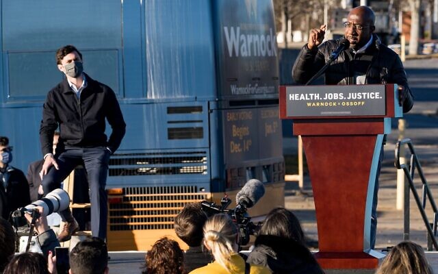 Rev. Raphael Warnock (R) speaks at a campaign event in Atlanta to promote voting in the Senate runoff election as Jon Ossoff, a fellow Democrat also running for Senate in Georgia, looks on, December 14, 2020. (Megan Varner/Getty Images) Rev. Raphael Warnock (R) speaks at a campaign event in Atlanta to promote voting in the Senate runoff election as Jon Ossoff, a fellow Democrat also running for Senate in Georgia, looks on, December 14, 2020. (Megan Varner/Getty Images)