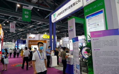 Shanghai-based testing kit company GeneoDx presents a booth at a trade fair in Nanchang in eastern China's Jiangxi province on Saturday, Aug. 22, 2020. (AP Photo/Dake Kang)