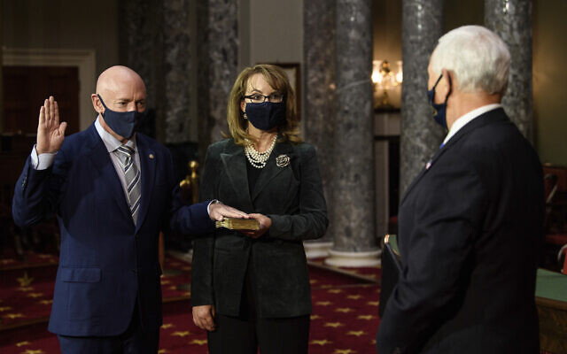 Sen. Mark Kelly, Democrat-Arizona, with his wife former Rep. Gabby Giffords, Democrat-Arizona, participates in a re-enactment of his swearing-in ceremony in the Old Senate Chamber on Capitol Hill in Washington, December 2, 2020. (Nicholas Kamm/Pool via AP) Sen. Mark Kelly, Democrat-Arizona, with his wife former Rep. Gabby Giffords, Democrat-Arizona, participates in a re-enactment of his swearing-in ceremony in the Old Senate Chamber on Capitol Hill in Washington, December 2, 2020. (Nicholas Kamm/Pool via AP)