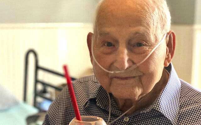 In this photo provided by Holly Wooten McDonald, World War II veteran and COVID-19 survivor Major Wooten holds a celebratory milkshake on his 104th birthday on Thursday, Dec. 3, 2020, in Madison, Alabama. Wooten was released from the hospital this week after contracting the illness caused by the new coronavirus before Thanksgiving. (Holly Wooten McDonald via AP) In this photo provided by Holly Wooten McDonald, World War II veteran and COVID-19 survivor Major Wooten holds a celebratory milkshake on his 104th birthday on Thursday, Dec. 3, 2020, in Madison, Alabama. Wooten was released from the hospital this week after contracting the illness caused by the new coronavirus before Thanksgiving. (Holly Wooten McDonald via AP)