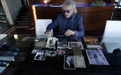 Jed Leiber shows photos of his grandfather Saemy Rosenberg's life, Dec. 3, 2020, at Leiber's home in Los Angeles. (AP Photo/Marcio Jose Sanchez)