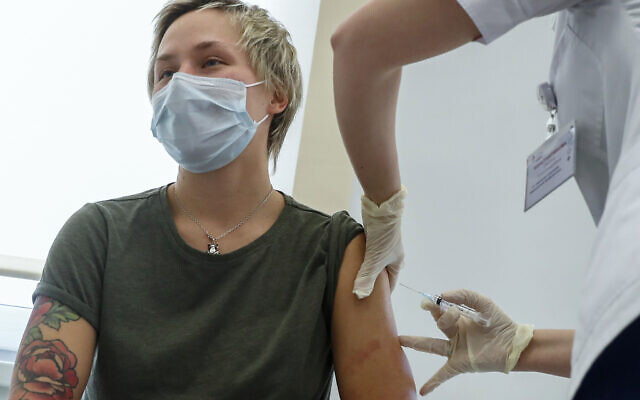 A Russian medical worker, right, administers a shot of Russia's Sputnik V coronavirus vaccine in Moscow, Russia, Saturday, Dec. 5, 2020. (AP Photo/Pavel Golovkin) A Russian medical worker, right, administers a shot of Russia's Sputnik V coronavirus vaccine in Moscow, Russia, Saturday, Dec. 5, 2020. (AP Photo/Pavel Golovkin)