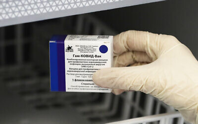 A medical worker moves a box of Russia's Sputnik V coronavirus vaccine out from a refrigerator prior to administering a vaccination in Moscow, Russia, Saturday, Dec. 5, 2020.  (AP Photo/Pavel Golovkin)