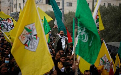 Palestinians attend the funeral of a 13-year-old Ali Abu Aliya who was reportedly shot dead by Israeli military forces during clashes with stone-throwing Palestinians, in the al-Mughayyir village near the West Bank city of Ramallah, Saturday, Dec. 5, 2020. (AP Photo/Majdi Mohammed)