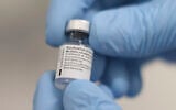 A phial of the Pfizer-BioNTech COVID-19 vaccine at the Royal Victoria Hospital, in Belfast, December 8, 2020. (Liam McBurney/Pool via AP)