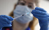 A nurse prepares a shot of the Pfizer-BioNTech COVID-19 vaccine at Guy's Hospital in London, UK, December 8, 2020. (Frank Augstein/AP)